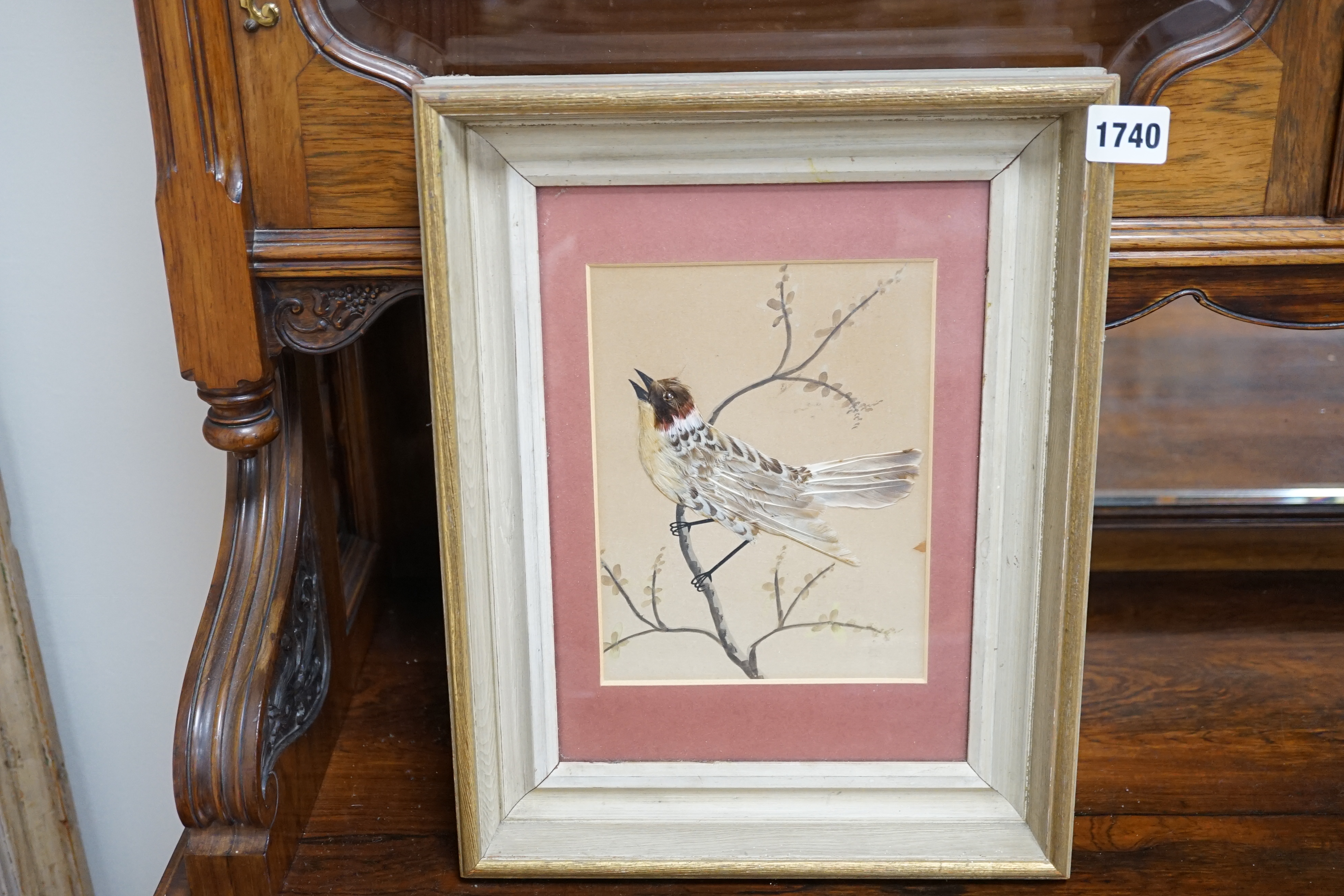 Late 19th / early 20th century, watercolour and feather picture, Bird on a branch, 19.5 x 14cm. Condition - poor to fair discolouration and tears to the paper